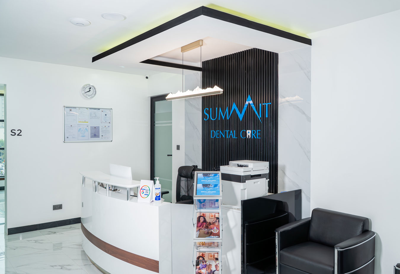 Summit Dental Care reception space with clinic branding and modern interior design